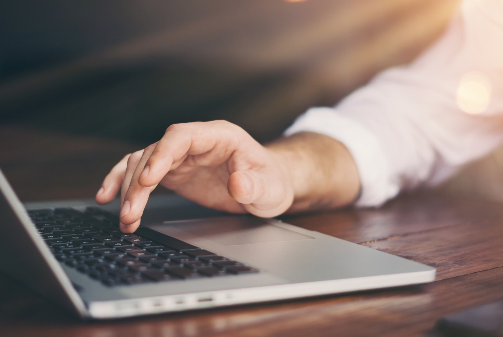 fingers on a laptop keyboard